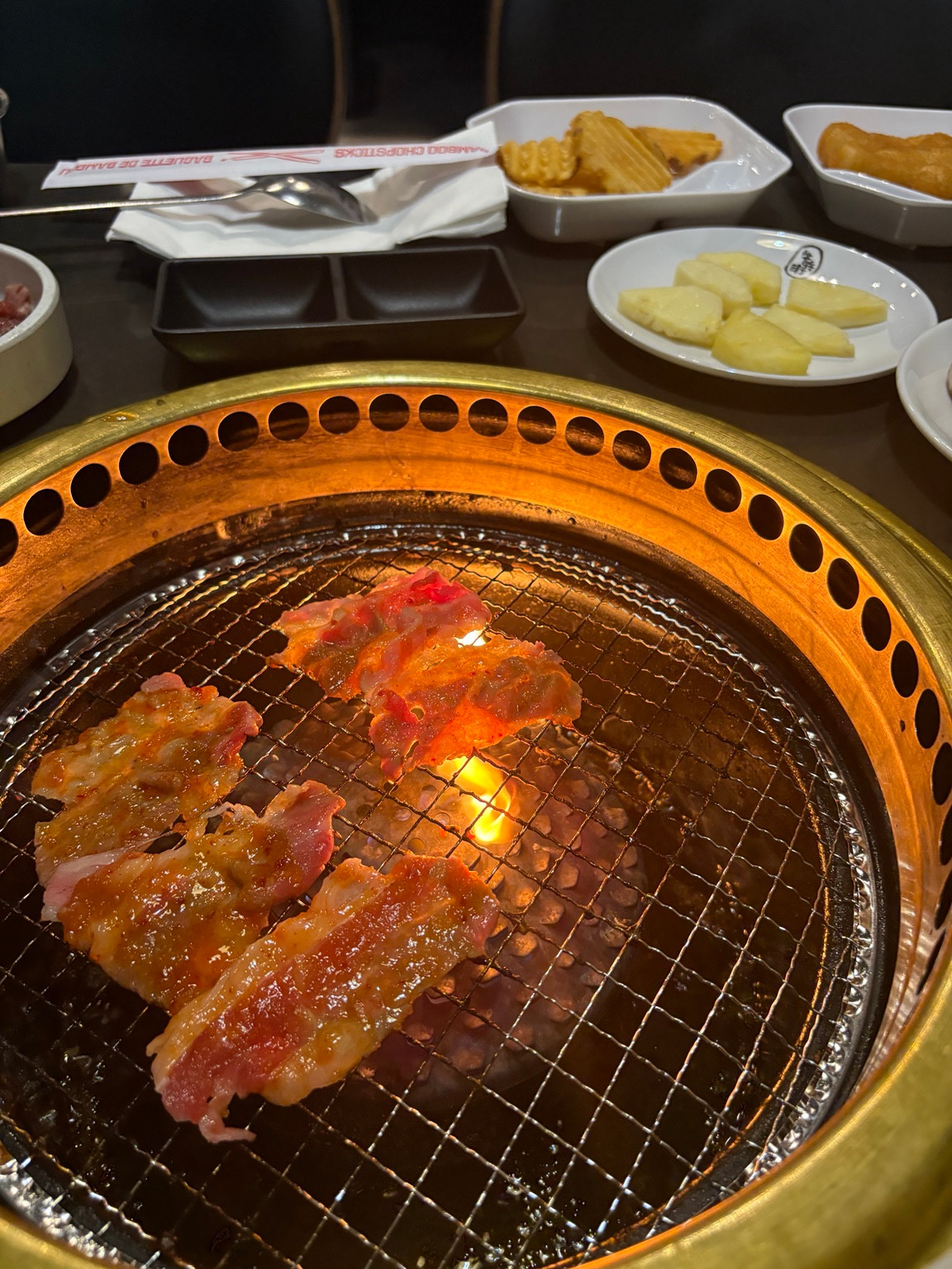 Food grilling over a flame at a Gyubee Merivale table